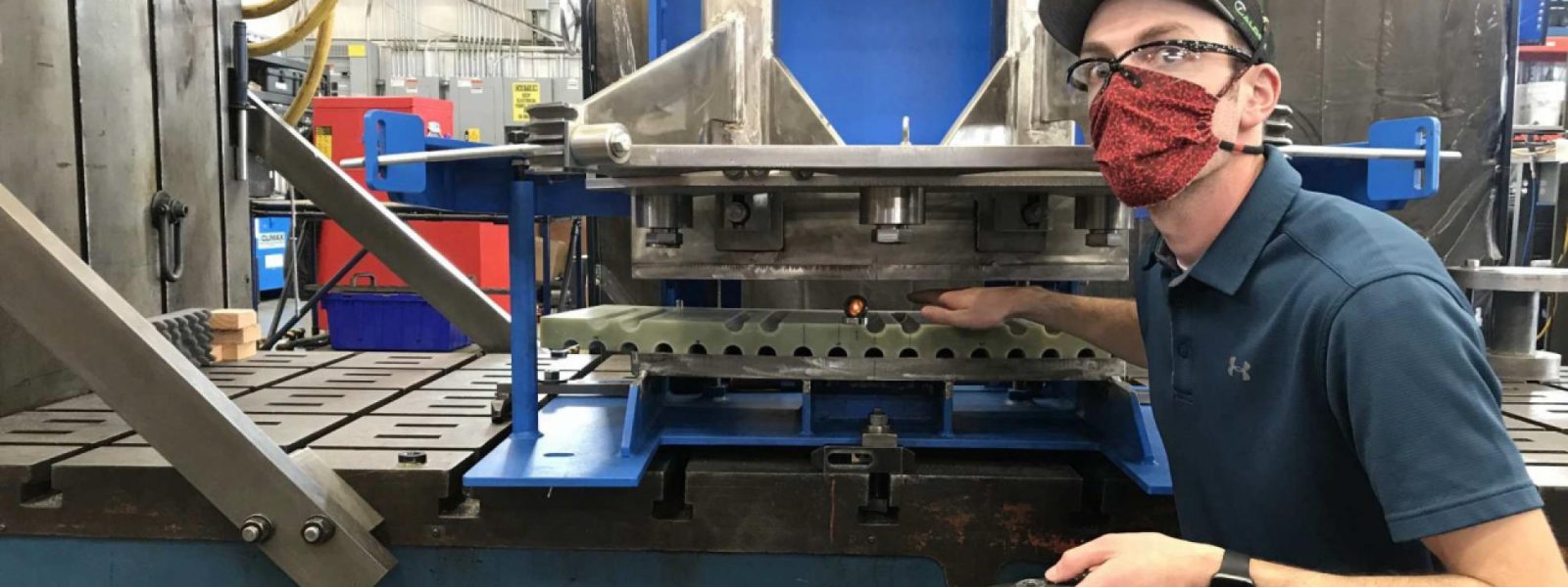 A Climax technician works on a shear pin drill fixture, a critical tool used to prevent rotational movement among the central solenoid superconducting magnets. Photo: Climax