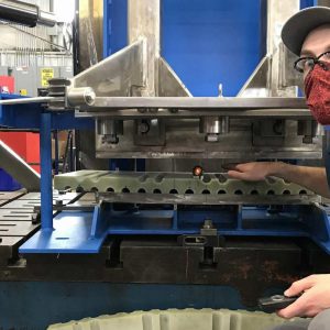 A Climax technician works on a shear pin drill fixture, a critical tool used to prevent rotational movement among the central solenoid superconducting magnets. Photo: Climax